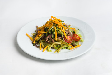 Plate of salad on white background