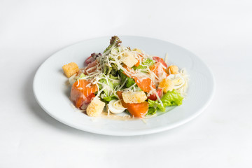 Plate of salad on white background