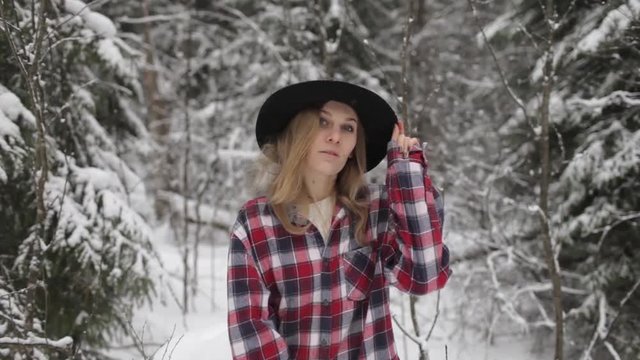 Beautiful Stylish Girl in Hat and Shirt in Winter Forest