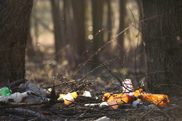 Nature pollution and waste plastic bottles. Plastic bottles garbage dump in the forest background.