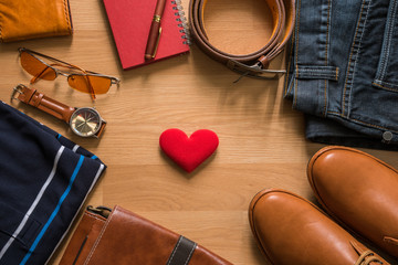 red heart and flat lay of men's casual fashion on white wooden floor