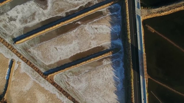Aerial. Video shooting over road and salt lakes in Tavira.