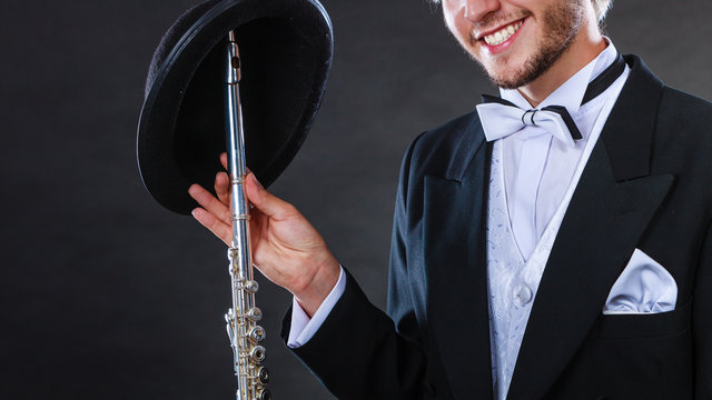 Elegantly dressed musician holding flute