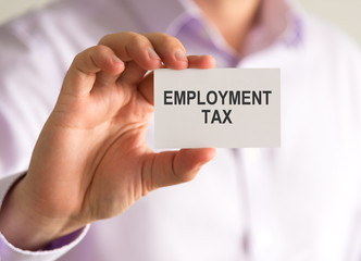 Businessman holding a card with EMPLOYMENT TAX message