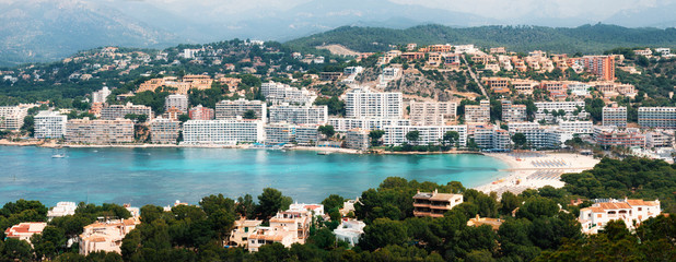 Aerial view of Santa Ponsa resort and the beach, MallorcaфBeautiful panoramic view from above of Santa Ponsa resort, the beach with white sand, sunbeds, hotels and yachts, Mallorca