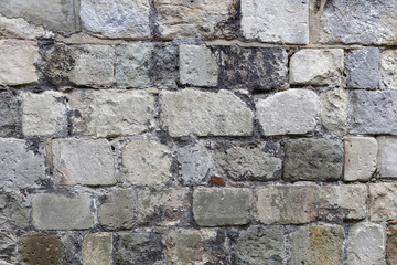 Stone wall made of gray stones of different shape