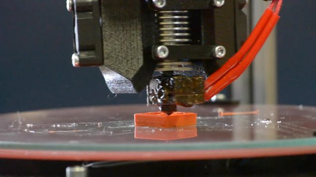 Modern 3D printer Printing figure close-up, additive manufacturing. Automatic three dimensional 3d printer performs plastic modeling in laboratory.