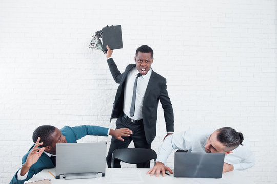 Firing from the company. Leaving the office. Furious ex-worker crashing his laptop. Stress at work, overworking, problem in the working team concept