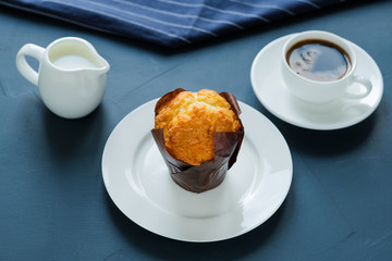 Breakfast. Coffee with milk and muffin.
