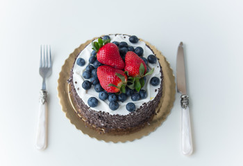 photo of tasty blueberry and strawberry on chocolate cake on the wonderful white background
