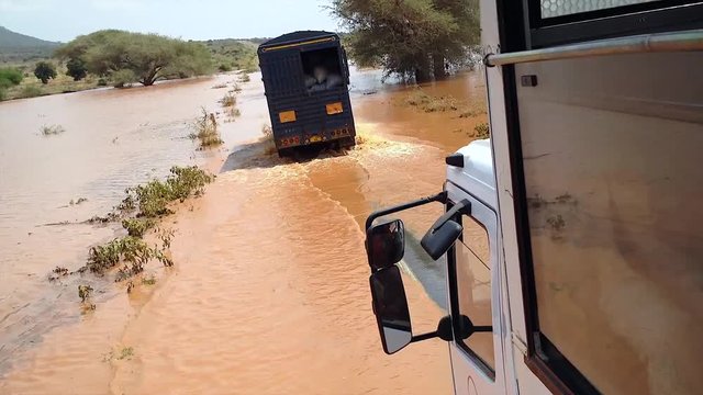 USAMBARA MOUNTAINS, TANZANIA - February 3: Trucks cross a flooded road after heavy rainfall on February 3, 2014 in Usambara Mountains, Tanzania.