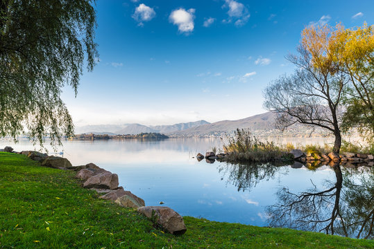 Lake Varese from Cazzago Brabbia, Italy. Nice and quiet sunny day on lake. From left to right: islet Virginia, Biandronno, Gavirate, Campo dei fiori. In the background the alps     