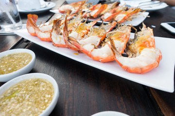 Grilled river prawns or shrimp on white dish in restaurant.selective focus