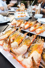 Grilled river prawns or shrimp on white dish in restaurant.selective focus