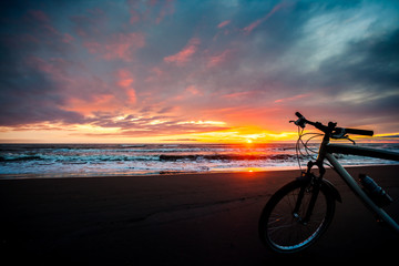 Tourist bike on the coast of the sea at sunset time