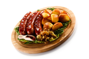 Grilled sausages served on cutting board