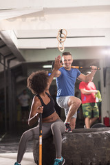 multiethnic couple after workout with hammer