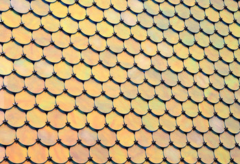 Geometrical pattern of many round holographic iridescent metal plates. horizontal background of modern tile roof with perspective. Metallic abstract bright mosaic texture.
