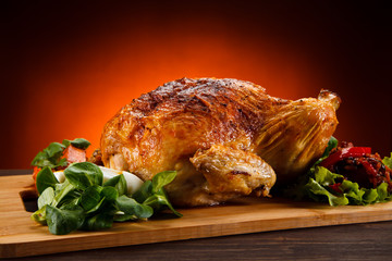 Roast chicken on cutting board