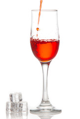 Red wine is poured into a glass On a white background