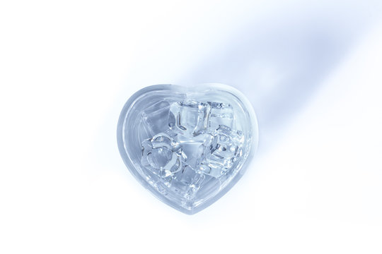 Water in glass heart on a white background