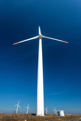 Wind turbines  against a blue sky generating electricity