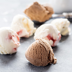 Vanilla and chocolate ice cream balls on background Close up