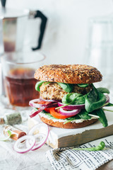 beefburger and coffee on restaurant table.