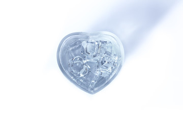 Water in glass heart on a white background