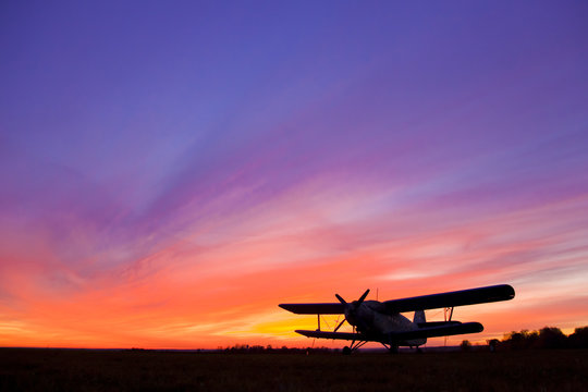 Fototapeta Airplane AN-2 on the airfield at sunset.
