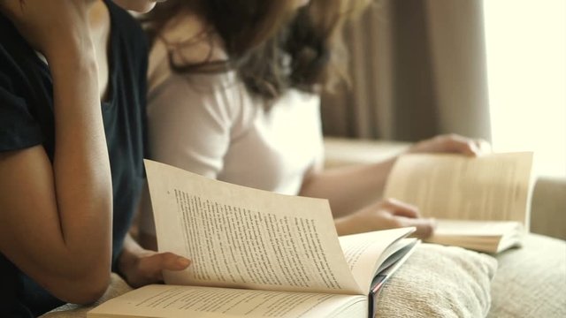 Two Adult Asian Women Reading Books At Home. Spend Quality Time Learning Something New