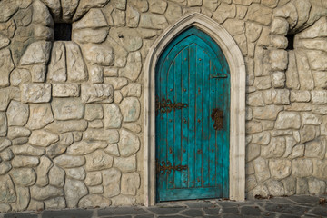 Obraz premium Old blue door with cobblestone wall