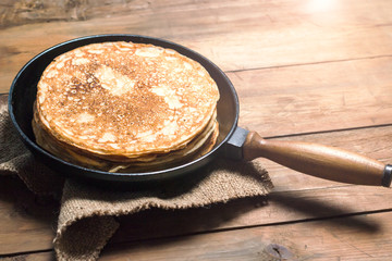 Stack of pancakes on a cast-iron frying pan