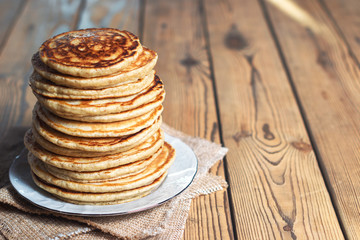 High stack of Oatmeal pancakes. The rustic style. With copy space. Shallow DOF