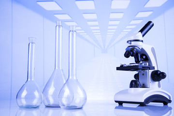 Laboratory work place with microscope and glassware