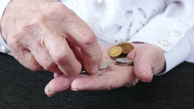 Coins In Old Woman Hands. Elderly Woman Counting Of Small Change Coins.