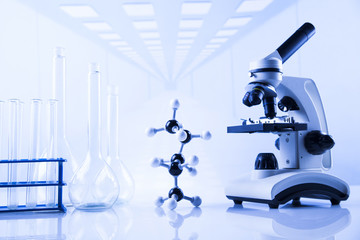 Laboratory work place with microscope and glassware