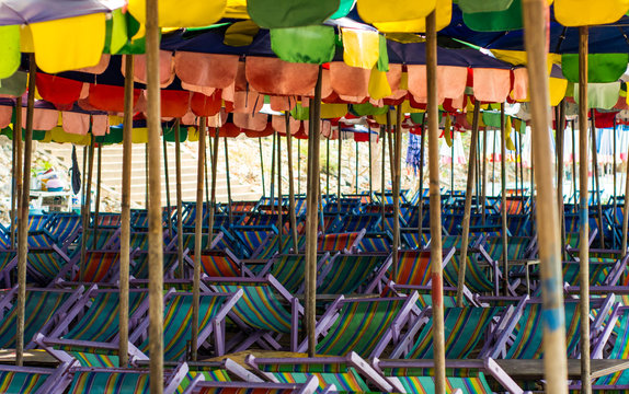 Old umbrella and chairs on beach