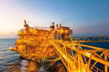 Offshore construction platform for production oil and gas with bridge in evening time
