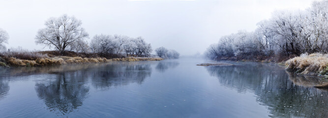 Panoranic view of river at fall misty morning
