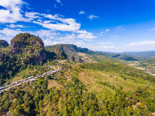Aerial view of small village on green mountain