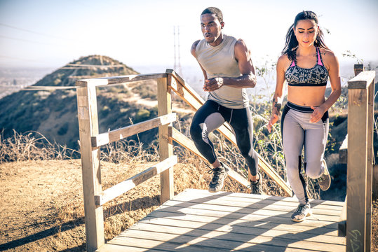 Couple Running In Los Angeles Canyons.  Making Exercises After Run