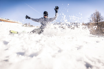 Snoboarder performing tricks on the snow © oneinchpunch