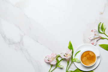Morning romantic breakfast. Coffee and flowers on marble background. Top view