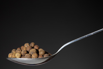 spoon with pile of allspice, Jamaica pepper or pimenta