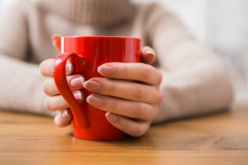 Close-up of woman with cup of hot drink