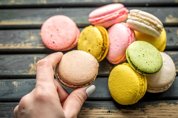 Colorful macaroons in the hands