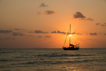 Fototapeta na wymiar boat sailing sunset