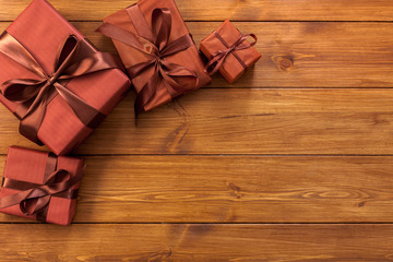 Presents in gift boxes on wood background with copy space