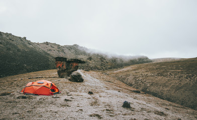 Orange Tent camping in foggy Mountains Landscape Travel Lifestyle concept Summer adventure vacations outdoor